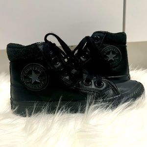 Kids all black Converse Chuck Taylor All Star high top sneakers.